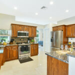 Kitchen with tile floor and wooden cupboards