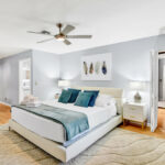 White Bed In a Room with Carpet